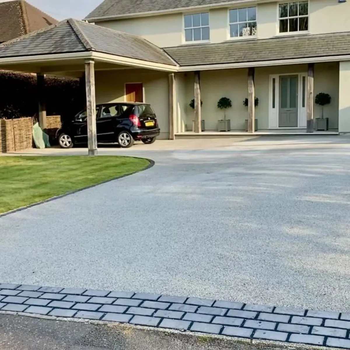 A resin bound driveway laid to a stone farmhouse by JR Landscapes & Driveways