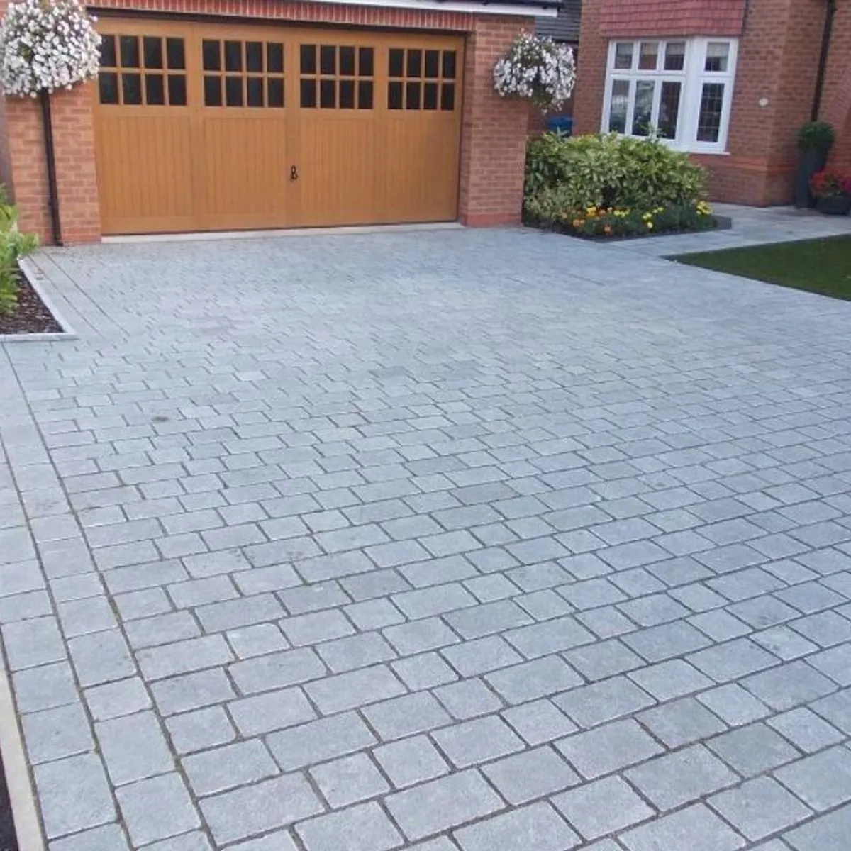 Silver grey block paved driveway and parking