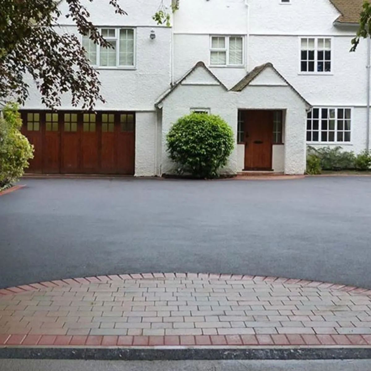 Tarmac driveway with a red block circular feature