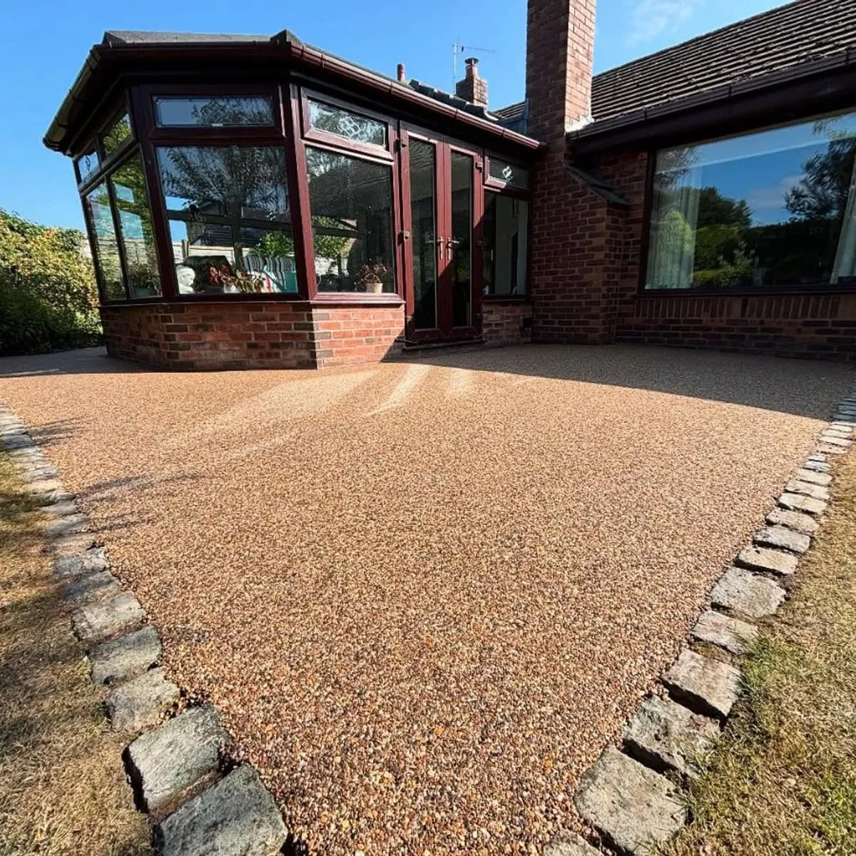 Resin patio and path beside a conservatory