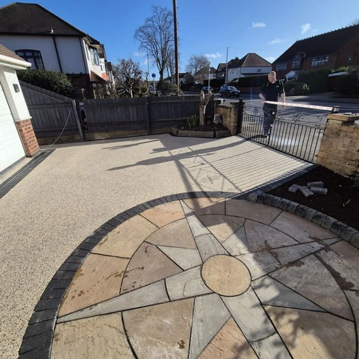 Circular sandstone patio feature in a lawn